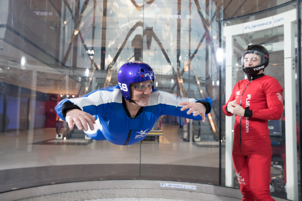 Man flying facing the camera with instructor closeup